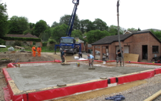 Concrete pump pouring passive slab foundation