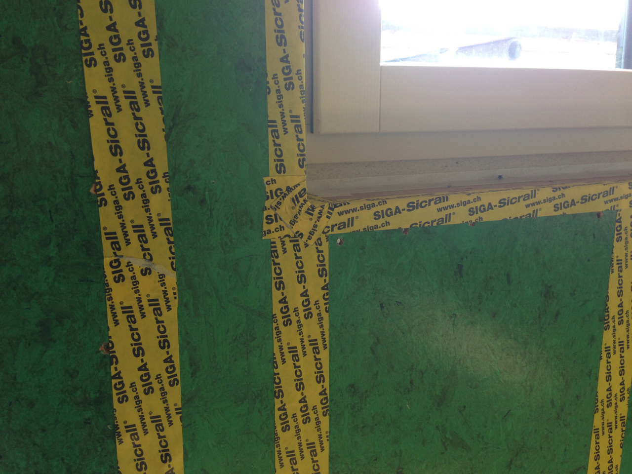 Tape on wall panel to window reveal junction