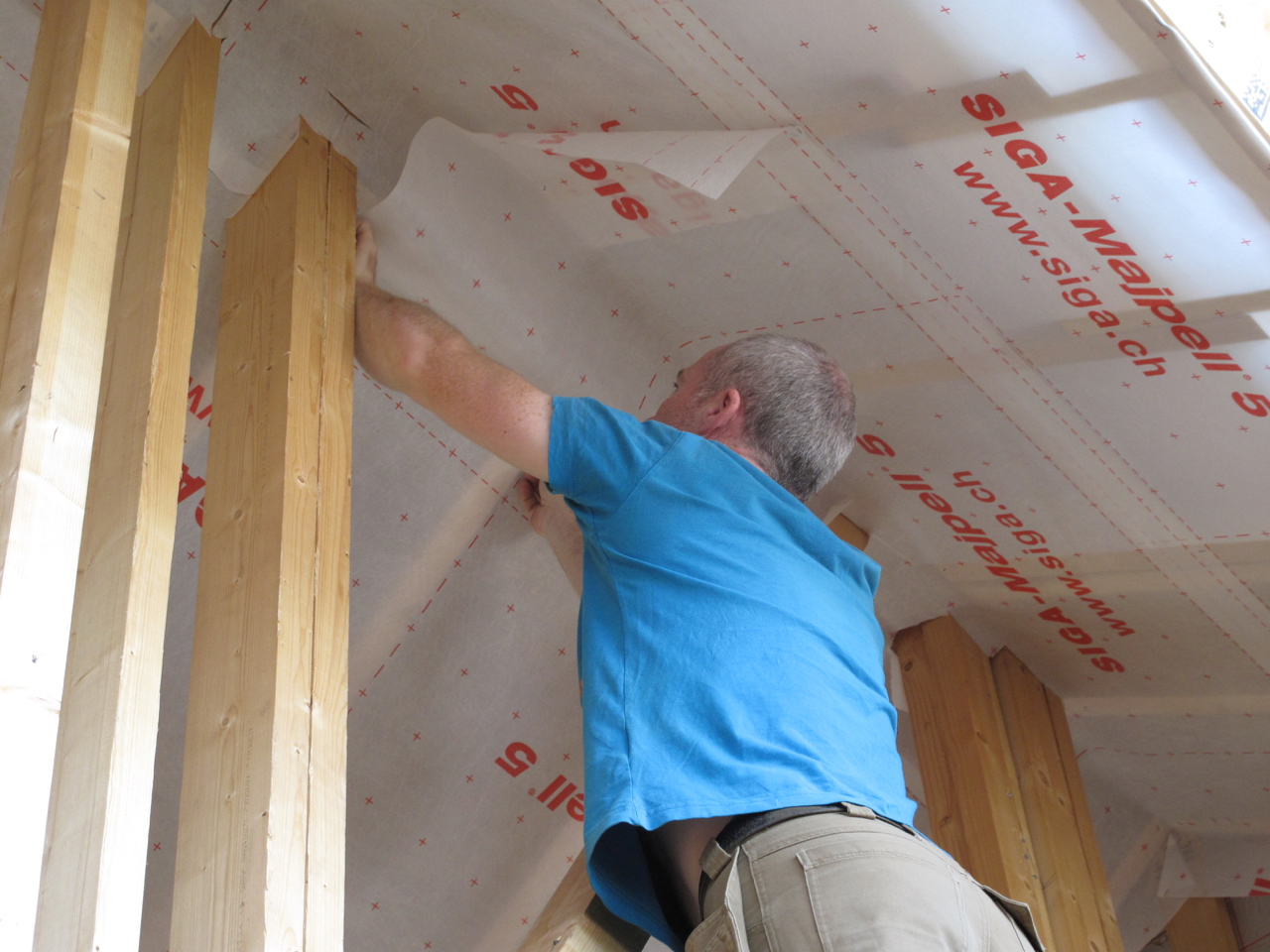 Fixing air tight membrane to underside of roof